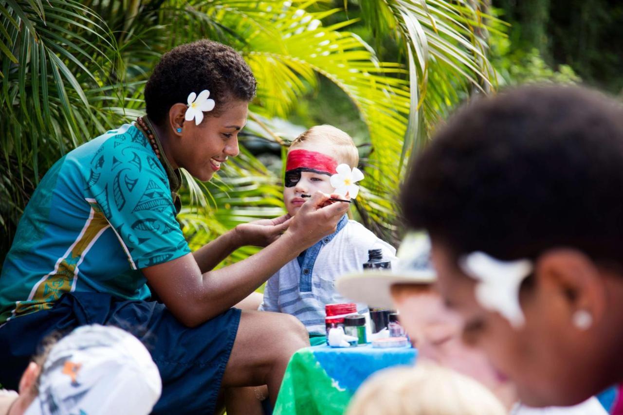 Outrigger Fiji Beach Resort Korotogo Dış mekan fotoğraf A young woman from the Cook Islands applying titi muka to a child's face
