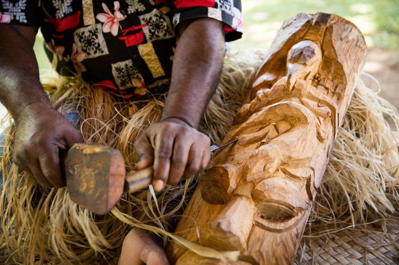 Outrigger Fiji Beach Resort Korotogo Dış mekan fotoğraf A man carving a mask in the Solomon Islands